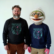 Two men wearing matching black and blue sweatshirts with a graphic design, standing next to each other.