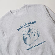 A gray sweatshirt with a graphic design featuring a cartoon rabbit and the text 