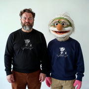 Two men standing next to each other, one wearing a black sweater with a panda graphic and the other wearing a blue sweater with a panda graphic.