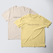 two t-shirts, one in a light beige color and the other in a bright yellow color, both with the same text printed on them.