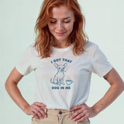 A woman wearing a white t-shirt with a graphic design of a dog and the text 