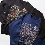 two sweatshirts with the same floral design and the text 