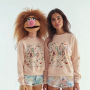 Two women standing next to each other, both wearing matching pink sweatshirts with the text 