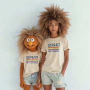 Two people wearing matching t-shirts with the text 