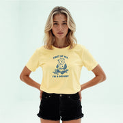 A young woman with blonde hair wearing a yellow t-shirt with a graphic of a panda and the text 