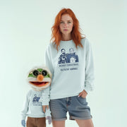 A woman wearing a white sweatshirt with a graphic of two men and the text 
