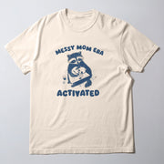 A white t-shirt with a graphic design featuring a raccoon holding a baby and the text 