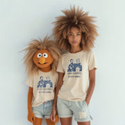 Two people wearing matching t-shirts with a Christmas-themed design stand together against a white background.