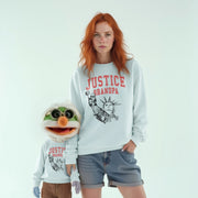 A woman wearing a white sweatshirt with the text 