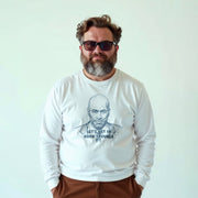 A man wearing a white long-sleeved shirt with a graphic of a bald man and the text 