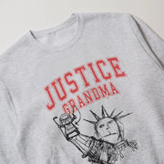 A grey sweatshirt with a graphic design featuring the Statue of Liberty and the text 