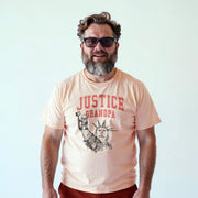 A man with a beard wearing a t-shirt with a graphic design and text printed on it.