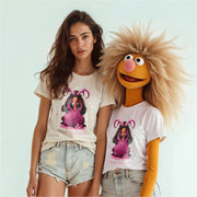 A woman wearing a white t-shirt with a graphic of a character and a man with a large, furry beard wearing a white t-shirt with a similar graphic.