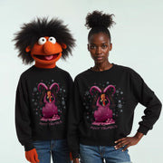 A person wearing a black sweater with a cartoon character and the text 
