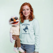 A woman wearing a light blue sweatshirt with a bird graphic and the text 