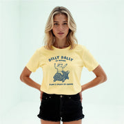 A young woman wearing a yellow t-shirt with a graphic of a turtle and the text 