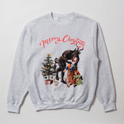 A gray sweatshirt with a Christmas-themed graphic design featuring a dark figure, a Christmas tree, and a person in a red coat.