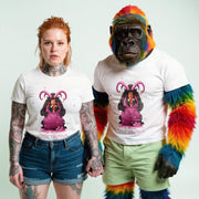 A woman with red hair wearing a white t-shirt with a graphic of a purple unicorn and the text 