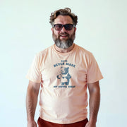 A man wearing a peach t-shirt with a graphic of a bear and the text 