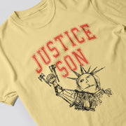 A yellow t-shirt with a graphic design featuring the Statue of Liberty and the text 