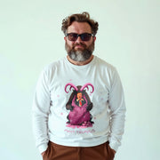 A man wearing a white long-sleeved shirt with a graphic of a purple unicorn and the text 