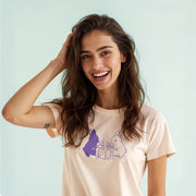 A smiling woman with long brown hair wearing a white t-shirt with a graphic of two rabbits.