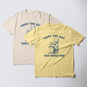 two t-shirts with a similar design, one in yellow and one in white. The yellow t-shirt has a graphic of a bear and the text 
