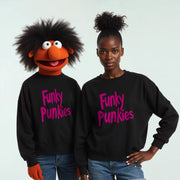 A person wearing a black sweater with the text 