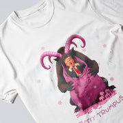 A white t-shirt with a graphic design depicting a man wearing a suit and tie, with horns and a pink dress, surrounded by snowflakes.