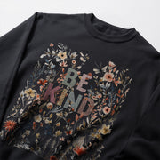 A black sweatshirt with a floral design and the text 
