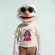A white and green plush toy with sunglasses and a t-shirt featuring a cartoon character is shown in the image.