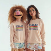 Two women wearing matching pink sweatshirts with the text 
